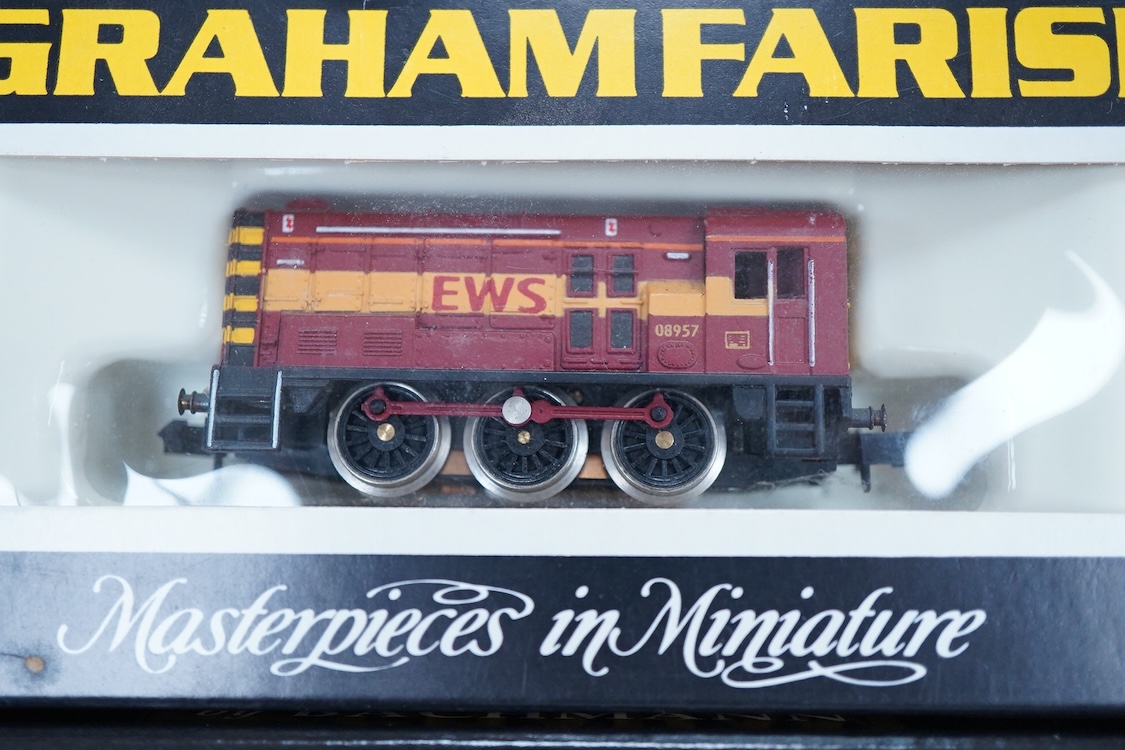 Four boxed Graham Farish N gauge railway Class 08 0-6-0 diesel locomotives; a BR, D3729 (371-001), a Railfreight Distribution, 08 653 (371-000), an EWS, 08957 (100F) and a Thomas 1, 08500 (1006).